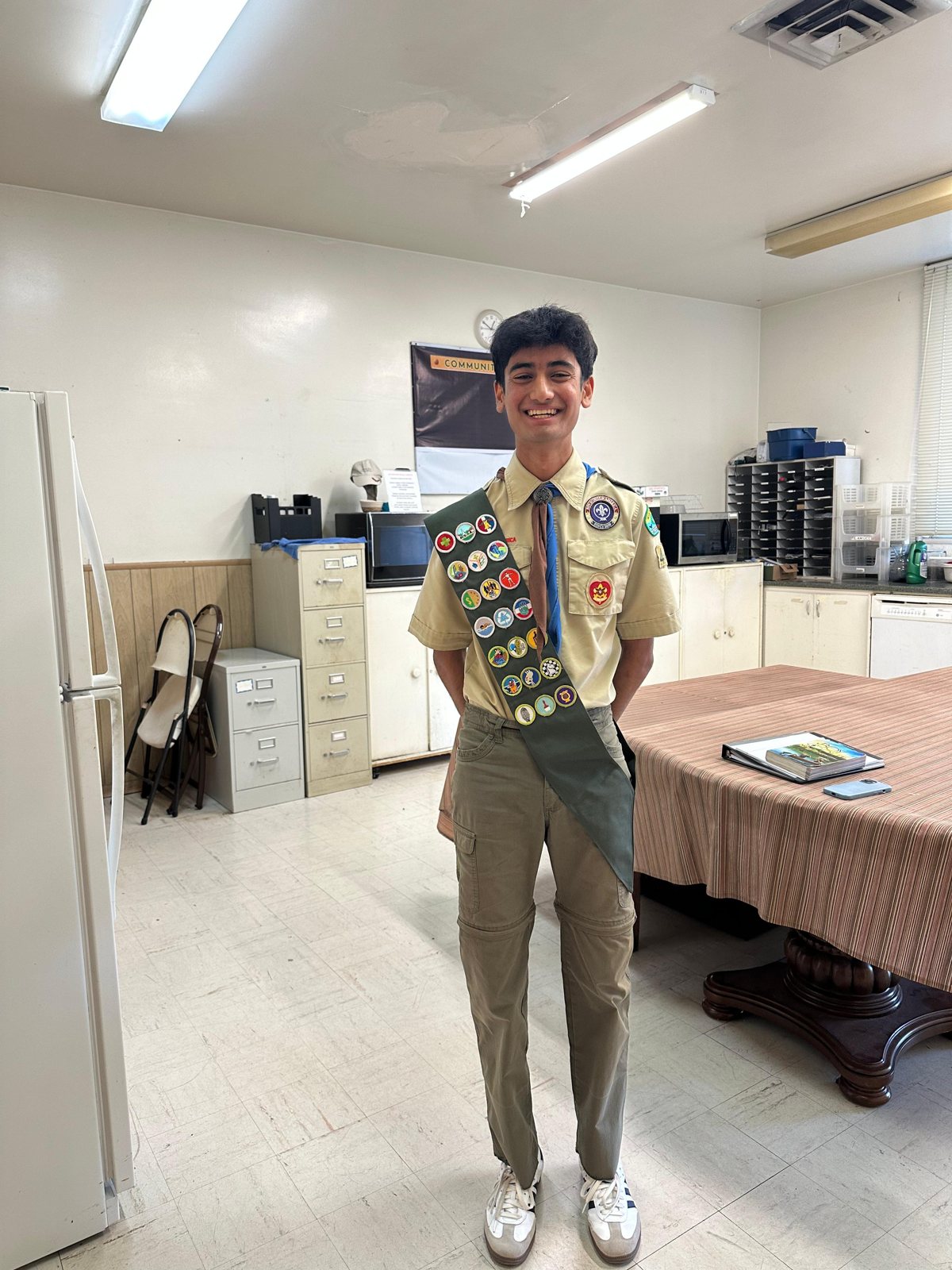 Vedant in uniform with his merit badge sash