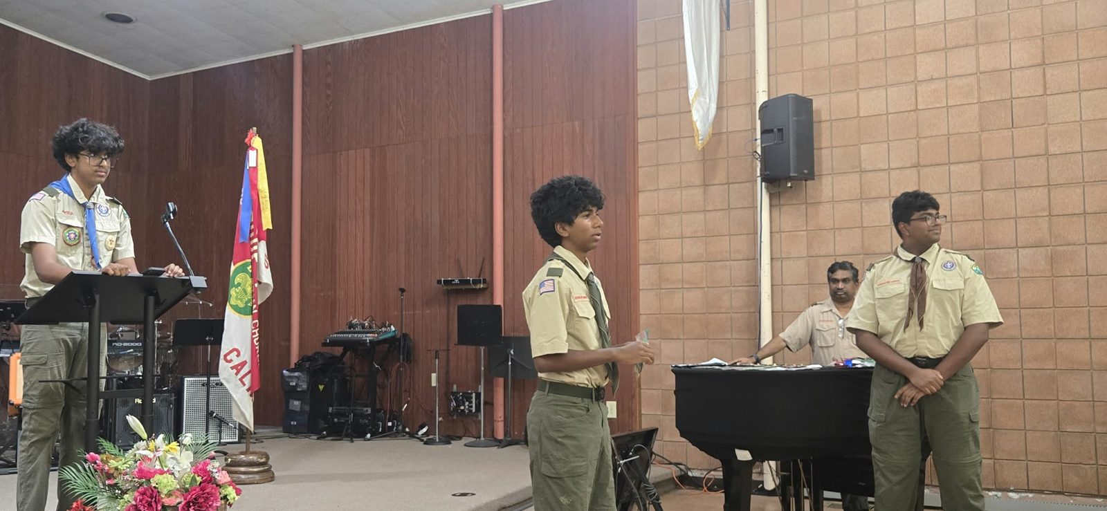 Scouts giving election speeches at a troop meeting